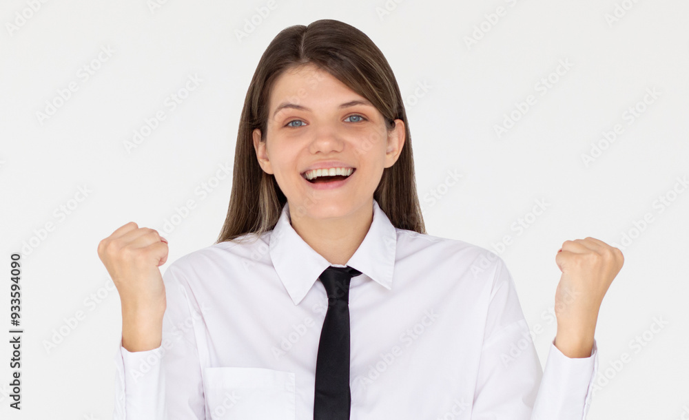 Portrait of ecstatic woman 20s wearing white shirt clenching fist like rejoicing victory or triumph isolated over white background Portrait of ecstatic woman 20s wearing white shirt clenching fist like rejoicing victory or triumph isolated over white background
