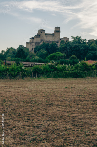 Torrechiara Castle in Parma. On the green hills. Italian hills with ears of wheat.