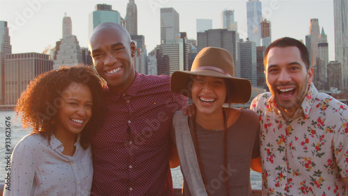 Картината върху платно Portrait Of Multi-Cultural Group Of Smiling Friends In Front Of Manhattan Skylin