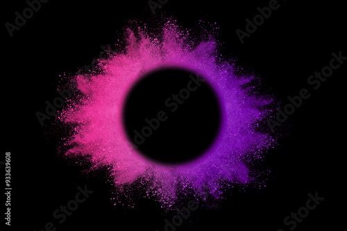 Explosion of colored powder and dust smoke splash pink and purple on black background