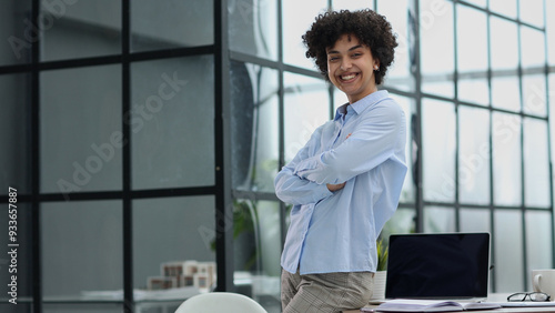 girl in the office smiles expresses success and leadership is thinking about success