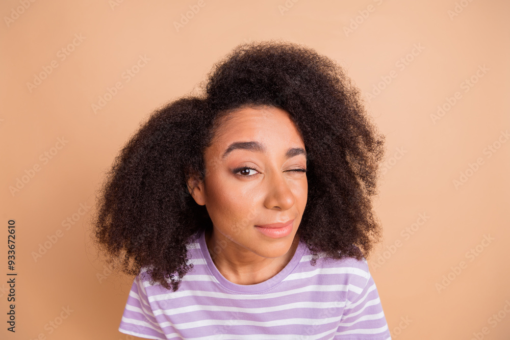 Photo of nice young woman eye look watch wear striped t-shirt isolated on beige color background Photo of nice young woman eye look watch wear striped t-shirt isolated on beige color background