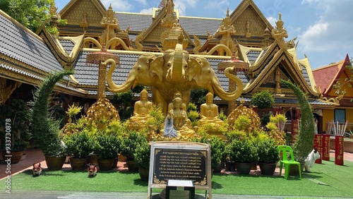 Atmosphere inside Wat Mai Supradittharam,Anonymous people worship or pray to the large Siwali statue and beautiful architecture. photo