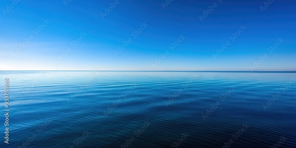 Clear blue sky reflecting on the calm ocean surface with a horizon line in the distance, serene, tranquil, peaceful, clear, sky Clear blue sky reflecting on the calm ocean surface with a horizon line in the distance, serene, tranquil, peaceful, clear, sky