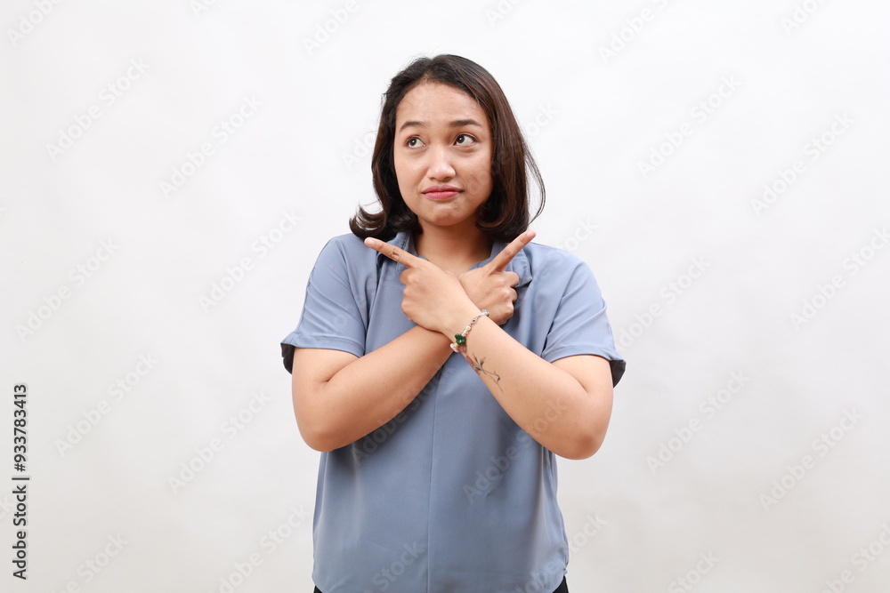Indecisive asian woman standing pointing fingers sideways, pointing fingers and looking clueless, confused with choices. Isolated on white background Indecisive asian woman standing pointing fingers sideways, pointing fingers and looking clueless, confused with choices. Isolated on white background