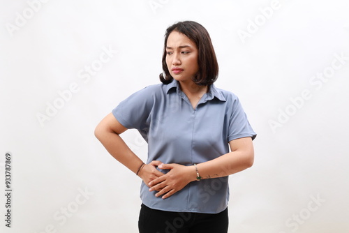 Woman's hand holding right stomach, suffering from stomach pain in the right side. Isolated on white