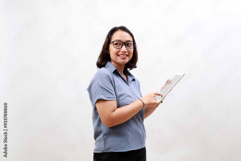 Smiling busy young asian business woman manager using tablet computer, happy business woman executive looking at empty space, standing over white background Smiling busy young asian business woman manager using tablet computer, happy business woman executive looking at empty space, standing over white background