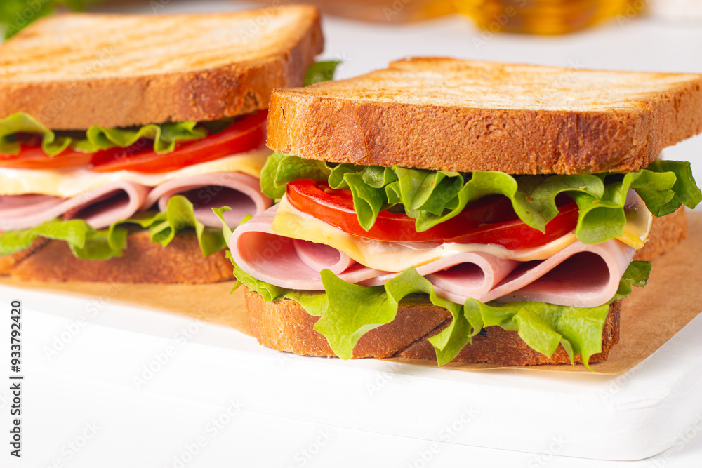 Club sandwich with ham, cheese, tomato and lettuce. Club sandwich with ham, cheese, tomato and lettuce.