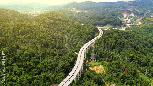 Aerial view of the Tree Giam Kanching bypass highway winding through the mountains of Rawang, Selangor, Malaysia surrounded by greenery. photo