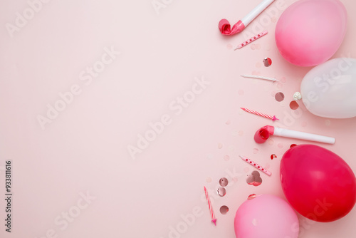 Birthday attributes colorful balloons, candles, and confetti. Concept of festive birthday celebrations photo