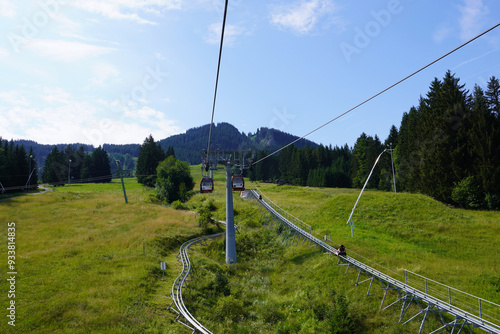 Fahrt mit dem Sessellift der Alpspitzbahn mit Blick auf die Berge und die Sommerrodelbahn in Nesselwang in Bayern	 photo