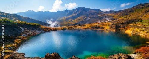 Serene landscape of hydrothermal springs with rich, colorful hues nestled in a volcanic area, surrounded by rugged terrain and geothermal steam clouds photo