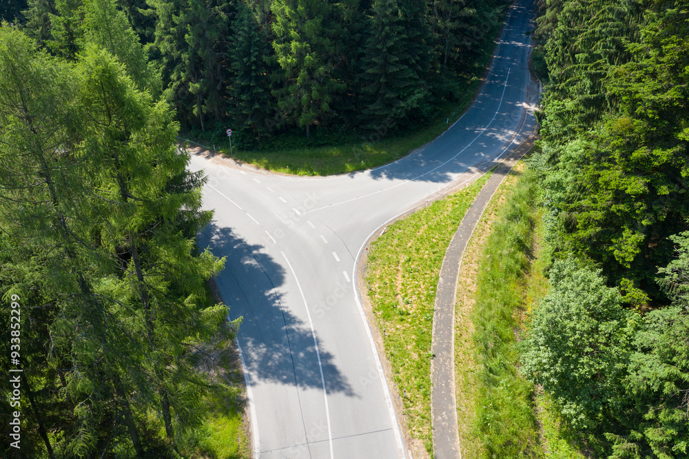 Fototapeta premium Road with asphalt coating. Heavy and light vehicle movement a road among the mountains. Paved road for car traffic, construction of a new paved road for transport in rural areas