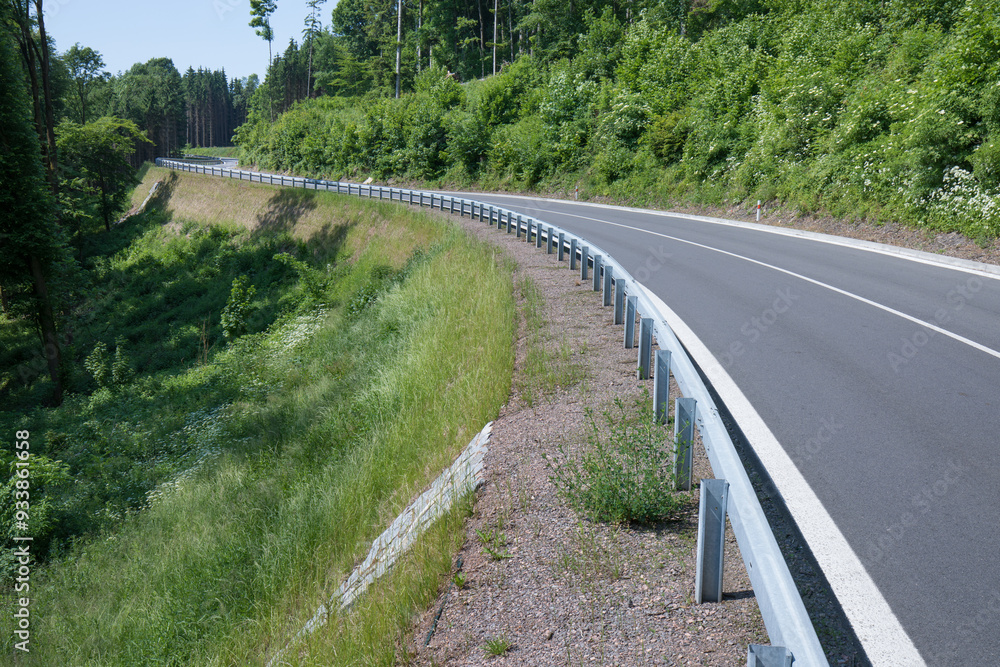 Road with asphalt coating. Heavy and light vehicle movement a road among the mountains. Paved road for car traffic, construction of a new paved road for transport in rural areas Road with asphalt coating. Heavy and light vehicle movement a road among the mountains. Paved road for car traffic, construction of a new paved road for transport in rural areas