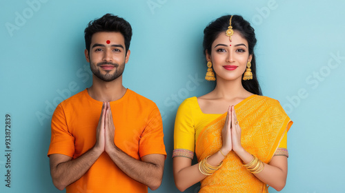 indian couple in traditional wear doing namaste photo