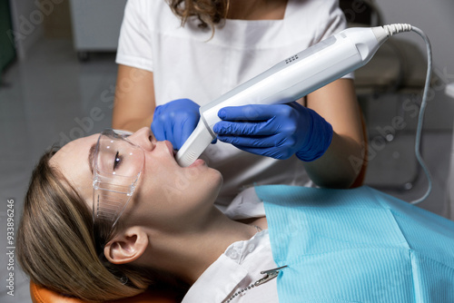 Orthodontist using a digital scanner to digitally capture the shape of teeth