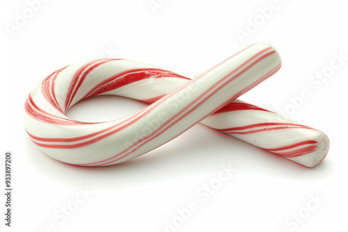 A colorful candy cane displayed among an assortment of sweets and confectionery indoors. Dominant color: White. photo