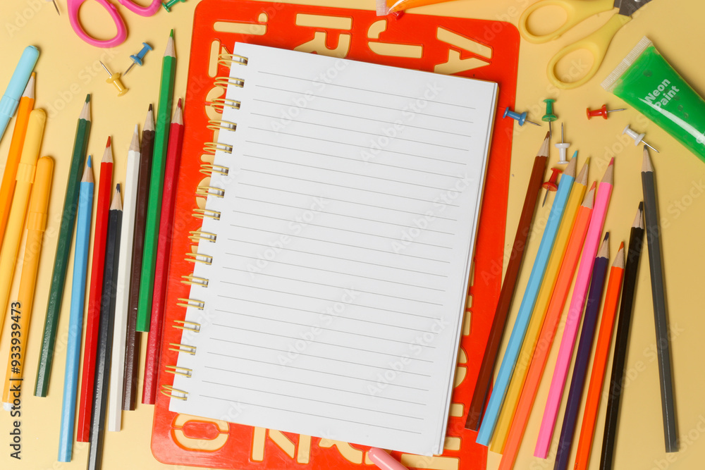 Back to school concept with variety of office and school supplies on yellow background. Back to school concept with variety of office and school supplies on yellow background.