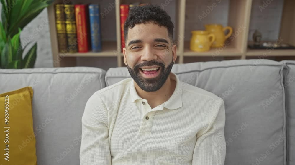 Funny, young hispanic man, joyfully sticking tongue out while making a happy and amusing expression at home, embodying a spirit of fun and positive emotion Funny, young hispanic man, joyfully sticking tongue out while making a happy and amusing expression at home, embodying a spirit of fun and positive emotion