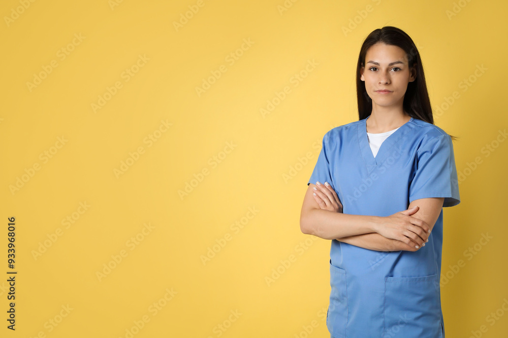 Portrait of beautiful nurse on yellow background. Space for text Portrait of beautiful nurse on yellow background. Space for text