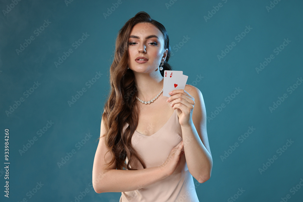 Poker game. Charming woman with playing cards on light blue background Poker game. Charming woman with playing cards on light blue background