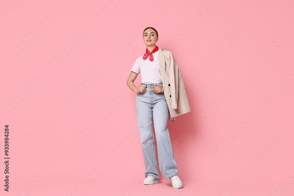 Stylish woman in beige jacket and jeans on pink background Stylish woman in beige jacket and jeans on pink background