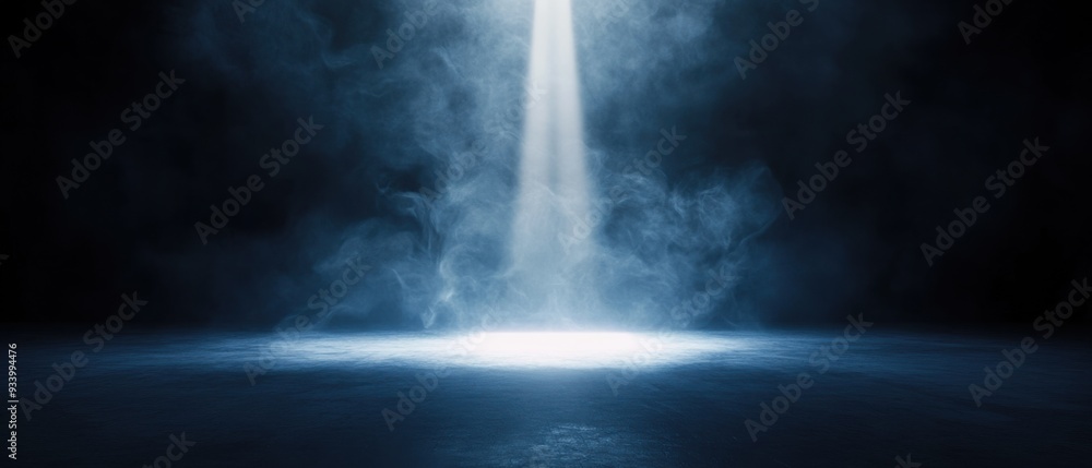 Fototapeta premium A dramatic spotlight illuminating swirling smoke in a dark, moody atmosphere with blue tones.