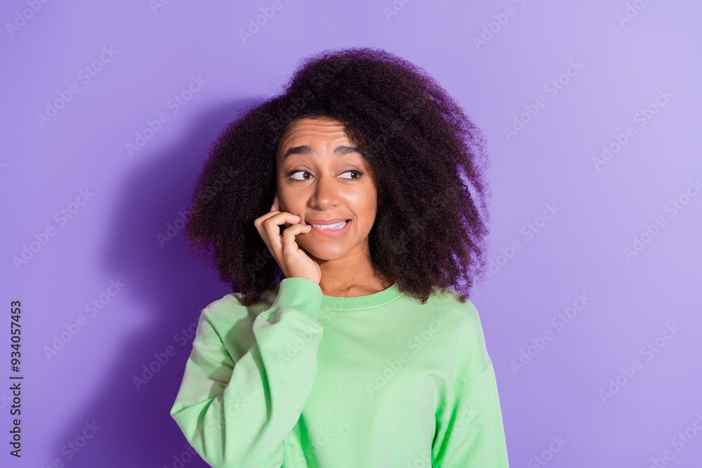 Photo portrait of young funky american teenage girl with chevelure hairstyle biting nails looking nervous panic isolated on purple color background Photo portrait of young funky american teenage girl with chevelure hairstyle biting nails looking nervous panic isolated on purple color background