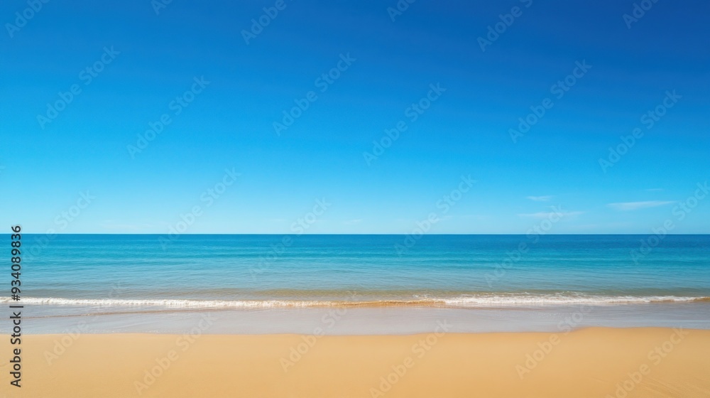 Fototapeta premium Serene Beachscape Under a Vast Blue Sky