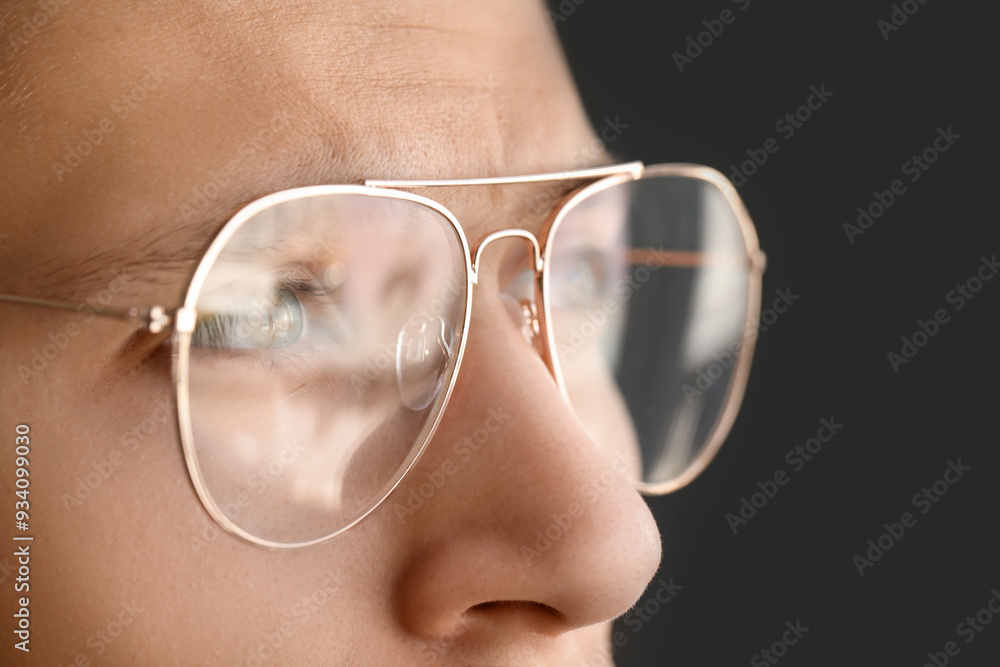 Vision correction. Man wearing glasses on grey background, closeup Vision correction. Man wearing glasses on grey background, closeup