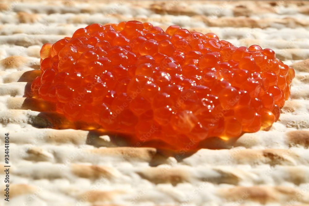 Red caviar on a matzah bread, closeup of photo. Shallow depth of field Red caviar on a matzah bread, closeup of photo. Shallow depth of field