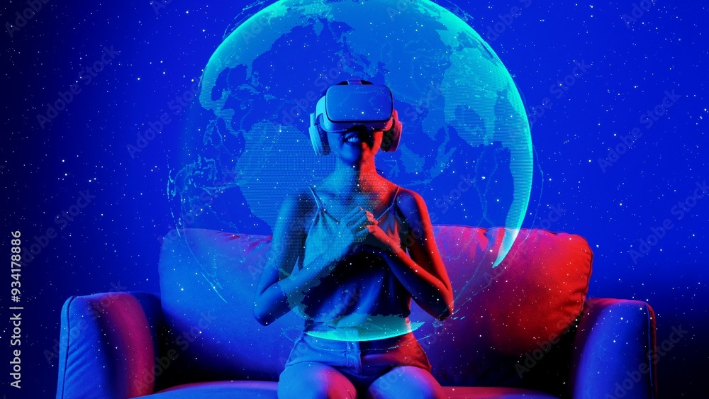 Naklejka premium Siting on sofa woman using VR turning rotate surface earth metaverse pointing bright lighting neon digital universe virtual space fantastic exploration nebula 3D meta global hologram. Hallucination.