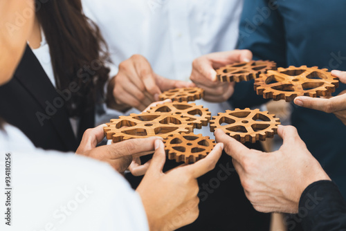 Business team joining cogwheel in circular together symbolize successful group of business partnership and strong collective unity teamwork in community workplace with productive efficiency. Prudent