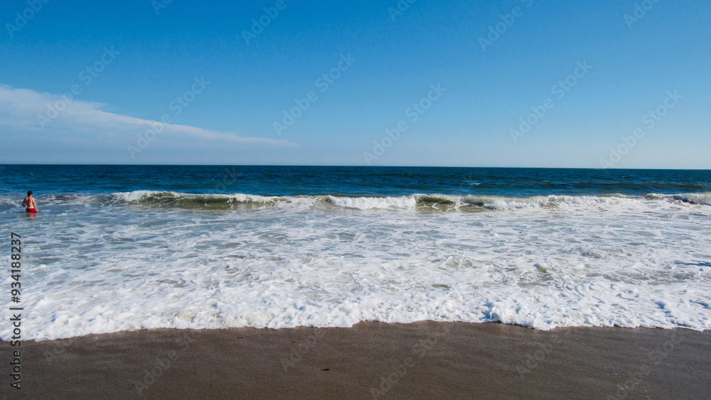waves crashing into shore of a beach waves crashing into shore of a beach