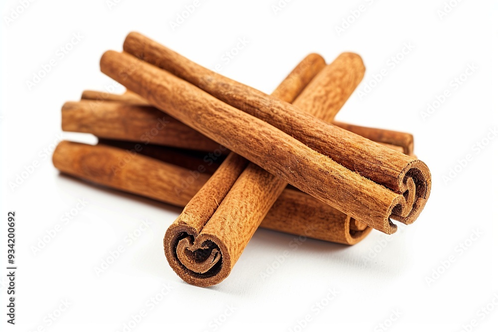 Sticks of cinnamon arranged on a white surface Sticks of cinnamon arranged on a white surface