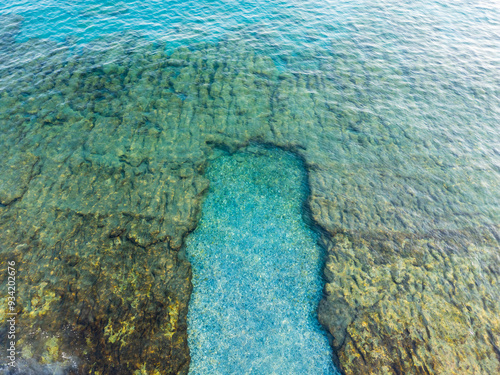 Aerial drone shot of the blue turquoise sea reef and beach
