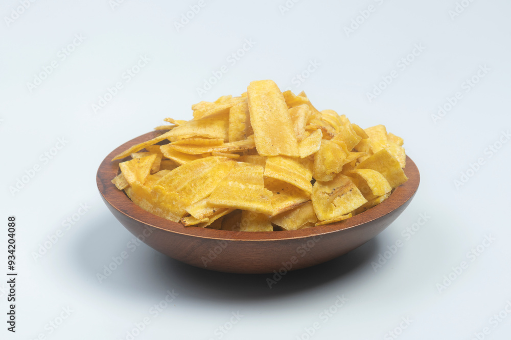 Studio shot of female hands picking Indian snack banana wafers from a scarved wooden bowl, isolated on white Studio shot of female hands picking Indian snack banana wafers from a scarved wooden bowl, isolated on white