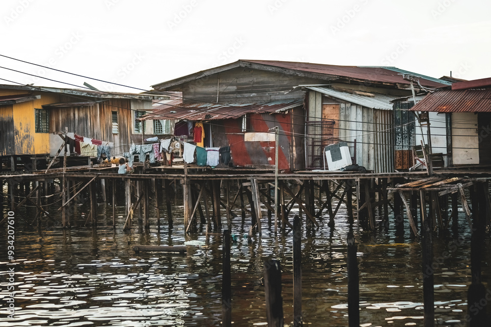 Fishing village houses over the water garbage poor areas in Sabah province in Malaysia Fishing village houses over the water garbage poor areas in Sabah province in Malaysia