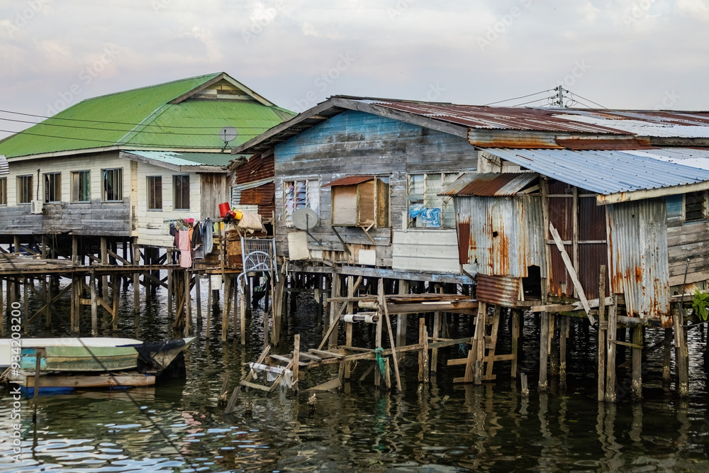 Fishing village houses over the water garbage poor areas in Sabah province in Malaysia Fishing village houses over the water garbage poor areas in Sabah province in Malaysia