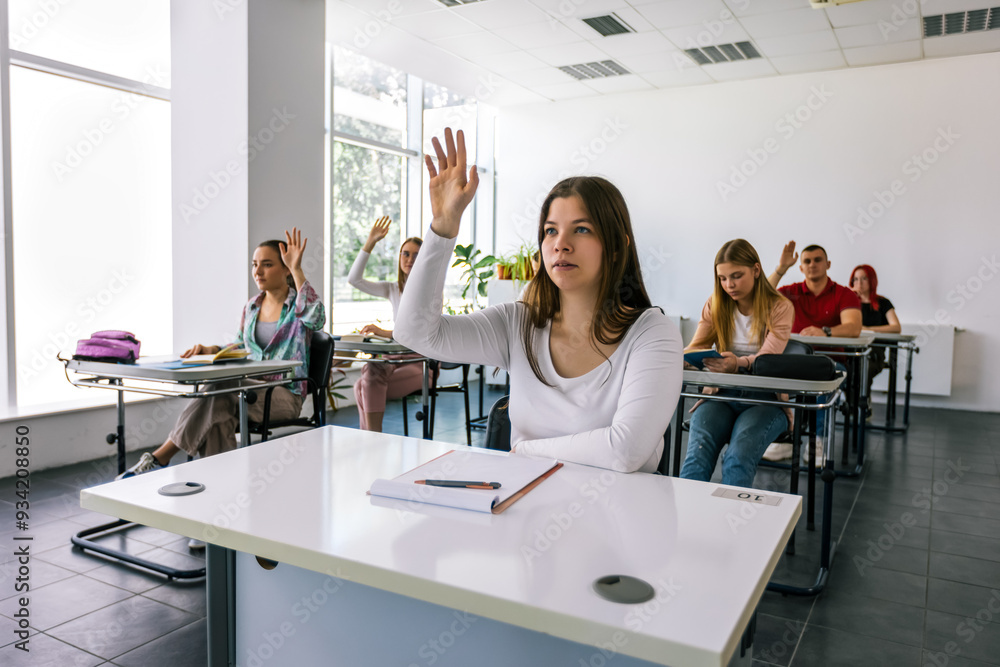 Obraz premium Female student raising her hand in class to ask some question