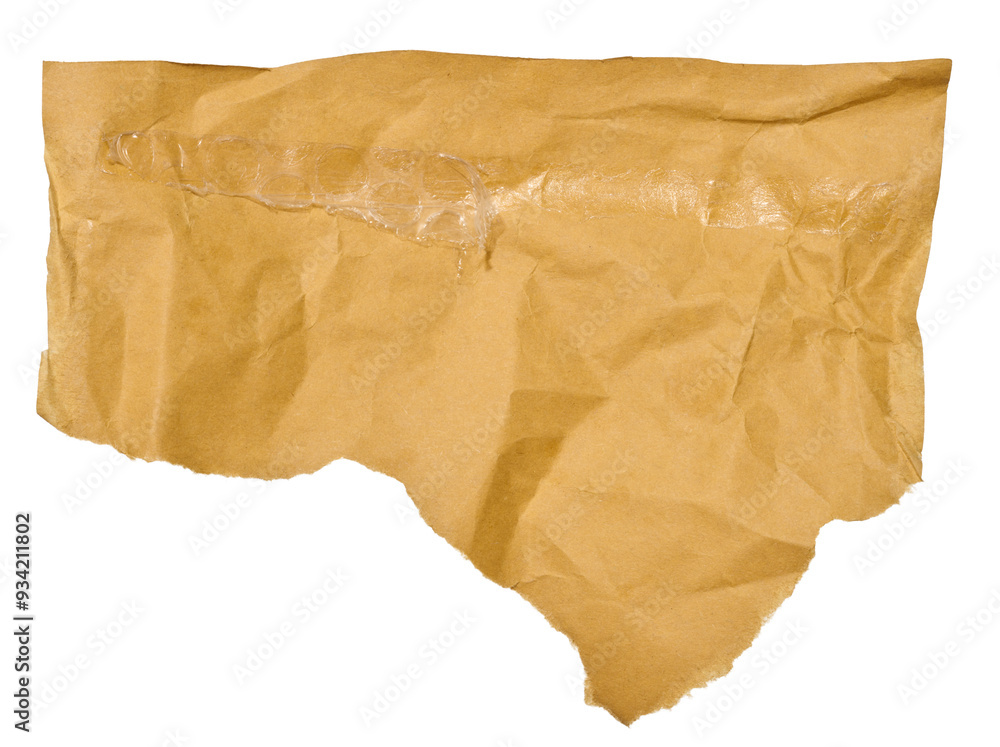 Torn piece of brown paper on a white isolated background, close up Torn piece of brown paper on a white isolated background, close up