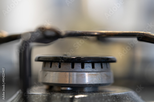 A moka pot on a gas stove, brewing coffee traditionally over an intense blue flame, with controlled heat from the gas stove. Gas ignition and various stages of the flame burning. 