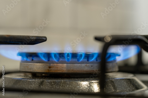 A moka pot on a gas stove, brewing coffee traditionally over an intense blue flame, with controlled heat from the gas stove. Gas ignition and various stages of the flame burning. 