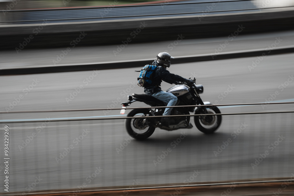 Fototapeta premium Photo of a motorbike driving through the city 