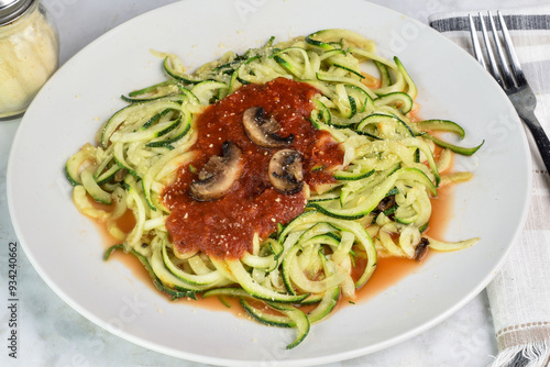 zucchini noodles top with sauce , mushrooms and cheese