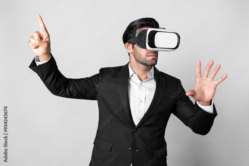 Skilled business man looking at data analysis while wearing VR glasses and suit. Project manager checking and choosing while using visual reality goggles or headset. Innovation technology. Deviation. Skilled business man looking at data analysis while wearing VR glasses and suit. Project manager checking and choosing while using visual reality goggles or headset. Innovation technology. Deviation.