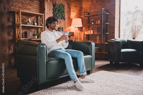 Photo of funky cool guy dressed white pullover communicating modern gadget indoors house apartment room