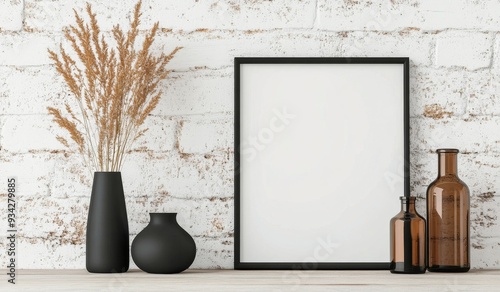 Minimalist interior decor with empty frame and dried flowers on a wooden table