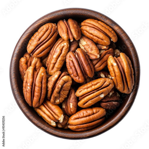 Neatly packed shelled pecans in dark wooden bowl top view isolated on transparent background 