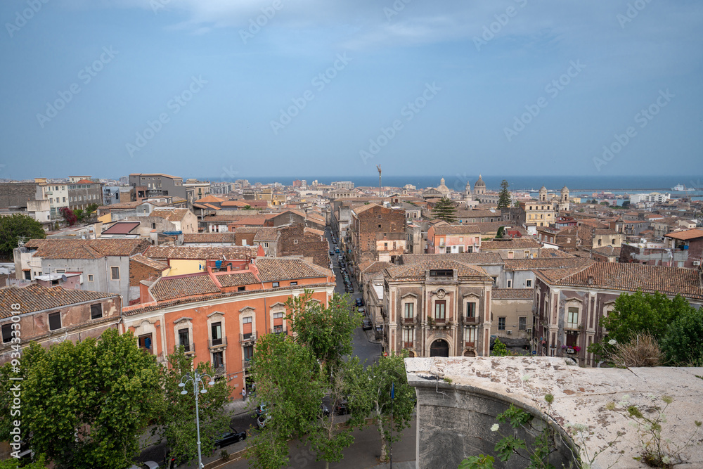 Naklejka premium Catania, Italy - May 18, 2024: Cityscape view from the observation deck on top of San Nicolo l'Arena church.